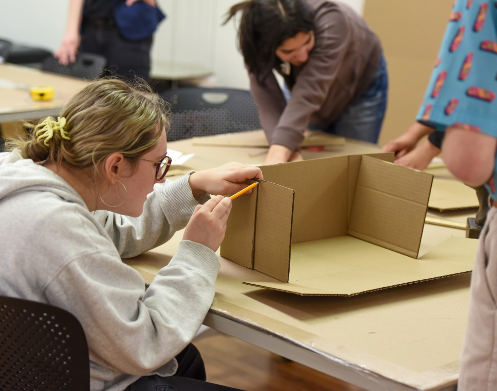 Students practice making custom boxes for collections storage